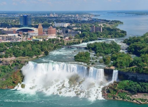 Niagara Falls Full Tour Guide: An In-Depth Exploration Introduction to Niagara Falls Niagara Falls is one of the most spectacular natural wonders in the world, straddling the border between the United States and Canada. Comprising three waterfalls—the Horseshoe Falls, the American Falls, and the Bridal Veil Falls—Niagara Falls draws millions of visitors each year. Its breathtaking beauty, rich history, and myriad activities make it an ideal destination for travelers of all kinds. This guide will provide a comprehensive overview of everything you need to know for a memorable trip to Niagara Falls. ________________________________________ 1. Getting There 1.1 Location Niagara Falls is located approximately 17 miles (27 km) north of Buffalo, New York, and about 75 miles (120 km) south of Toronto, Canada. 1.2 Transportation • By Car: Accessible via major highways, including the I-90 and QEW. Parking is available at various locations around the falls. • By Air: The nearest airports are Buffalo Niagara International Airport (BUF) and Toronto Pearson International Airport (YYZ). Both offer rental car services and shuttle options. • By Train: Amtrak provides train services to Niagara Falls from major U.S. cities, while Via Rail offers services from Toronto. • By Bus: Several bus companies operate services to Niagara Falls from various cities, including Greyhound and Megabus. ________________________________________ 2. Best Time to Visit • Spring (March to May): Mild temperatures, blooming flowers, and fewer crowds. Ideal for outdoor activities. • Summer (June to August): Warm weather and vibrant tourist activities. However, it can be crowded. • Fall (September to November): Spectacular fall foliage and comfortable temperatures. A fantastic time for photography. • Winter (December to February): As cold as it gets, the winter landscape is of particular beauty, and the area is less crowded. Winter festivals, like the Niagara Falls Winter Festival of Lights, add more charm. ________________________________________ 3. Accommodations 3.1 Hotels • Luxury: o Niagara Falls Marriott Fallsview Hotel & Spa offers panoramic views of the falls. o The Oakes Hotel Overlooking the Falls has spacious rooms with direct views. • Mid-range: o Comfort Inn The Pointe is conveniently located near the falls. o Days Inn by Wyndham Niagara Falls Near the Falls offers comfortable amenities. • Budget: o Hostel in the Falls for affordable dormitory-style accommodations. o Motel 6 Niagara Falls is a budget-friendly option with basic amenities. 3.2 Camping For nature enthusiasts, campgrounds like Four Mile Creek State Park and Niagara Falls State Park offer a unique way to experience the natural beauty of the region. ________________________________________ 4. Must-See Attractions 4.1 Niagara Falls • The Horseshoe Falls: The largest of the three, known for its powerful flow. The observation deck offers stunning views. • The American Falls: Smaller but equally captivating, it's popular for photography and viewing platforms. • Bridal Veil Falls: The smallest but most intimate, accessible via the Cave of the Winds. 4.2 Maid of the Mist This historic boat tour brings you near the base of the falls, which is an awe-inspiring experience. Be ready to get splashed as you move towards the roaring water. 4.3 Cave of the Winds See the falls from close quarters via a series of wooden boardwalks that bring you to the foot of Bridal Veil Falls. The "Hurricane Deck" has stunning views and intense spray. 4.4 Niagara Parks Botanical Gardens A 99-acre botanical garden with more than 2,400 types of plants, ideal for casual walks and picnics. 4.5 Journey Behind the Falls Descend by elevator to tunnels leading to observation decks behind the falls for a one-of-a-kind view. ________________________________________ 5. Activities and Experiences 5.1 Adventure Activities • Ziplining: Get the rush of ziplining above the Niagara River, with stunning views of the falls. • Hiking: Hike on trails such as the Niagara Gorge Rim Trail, which offers scenic views and varying degrees of difficulty. • Biking: Bike on the Niagara River Recreational Trail, a scenic bike ride along the river, by renting a bike. 5.2 Wine Tours Niagara-on-the-Lake is renowned for its wineries. Sample local wines, particularly the world-renowned Ice Wine. 5.3 Cultural Experiences • Niagara Falls History Museum: Offers information on the history and significance of the falls. • The Shaw Festival: A renowned theater festival in nearby Niagara-on-the-Lake, featuring a variety of performances. ________________________________________ 6. Dining Options 6.1 Fine Dining • Skylon Tower: Dine with a panoramic view of the falls from 775 feet above. • Windows by Jamie Kennedy: A farm-to-table experience offering exquisite local dishes. 6.2 Casual Dining • The Rainforest Café: A family-friendly atmosphere with a diverse menu. • BeaverTails: Famous for its delicious pastries, perfect for a quick snack. 6.3 Cafés and Bakeries • Queenston Heights Restaurant: Offers casual dining and stunning views. • Pioneer Coffee: A cozy café renowned for its handmade coffee and pastries. ________________________________________ 7. Safety Tips • Weather: Dress in layers and prepare for sudden changes in weather, especially near the falls. • Stay on Paths: Always stay on established paths and observation points for safety. • Hydrate: Bring water, especially in summer, as outdoor activities are exhausting. • Wildlife: Be aware of your surroundings; avoid feeding or approaching wildlife. ________________________________________ 8. Useful Information 8.1 Currency • The U.S. and Canadian dollar are both accepted, but check exchange rates for the best deals. 8.2 Language • English is the primary language, but you may encounter French speakers, especially in Canada. 8.3 Time Zone • Niagara Falls is in the Eastern Time Zone (UTC-5). 8.4 Mobile Connectivity • Cell service is generally reliable, but some areas near the falls may have limited connectivity. ________________________________________ 9. Conclusion A visit to Niagara Falls offers unforgettable experiences abounding in nature, adventure, and relaxation. Whether you stand in wonder on the brink of the falls, take a boat tour, or indulge in local food, you'll have memories that will last a lifetime. With its numerous attractions and activities, Niagara Falls has something for everyone. ________________________________________ By following this guide, you’ll be well-equipped to explore all that Niagara Falls has to offer. Enjoy your adventure!
